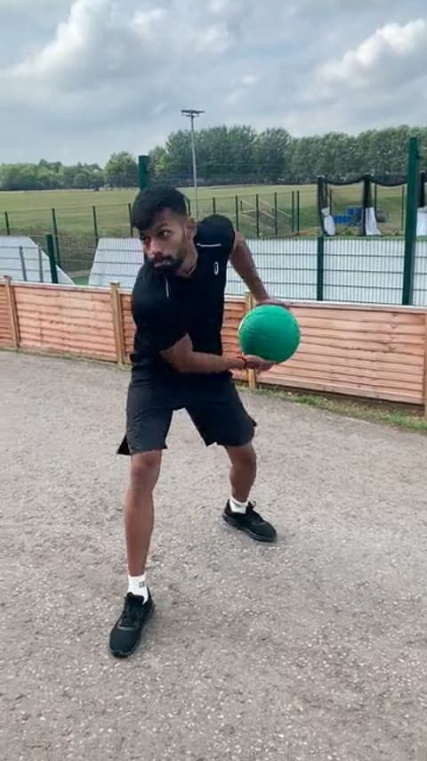 A bowler doing a medicine ball side throw